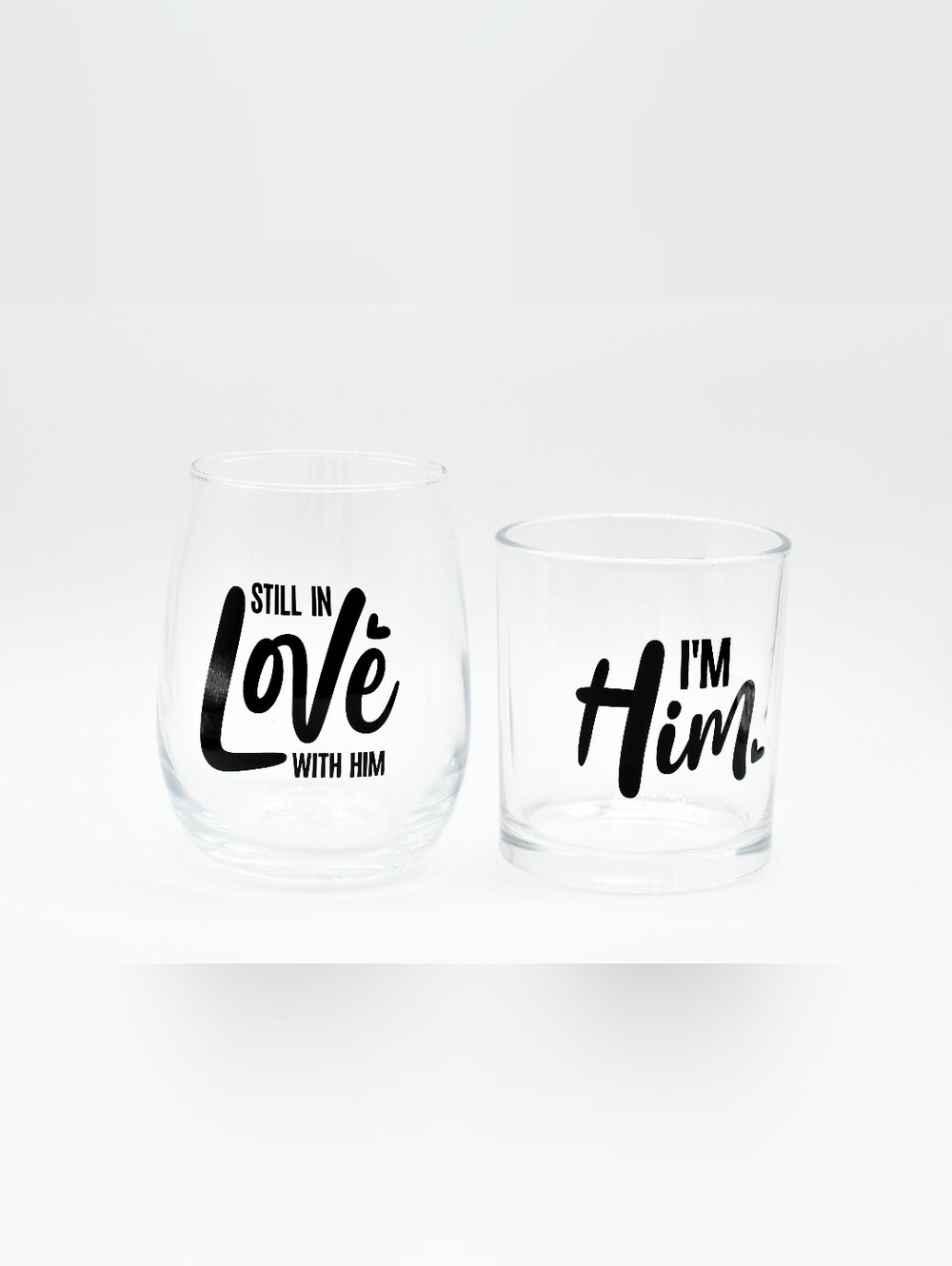 Set of two clear drinking glasses with bold black lettering